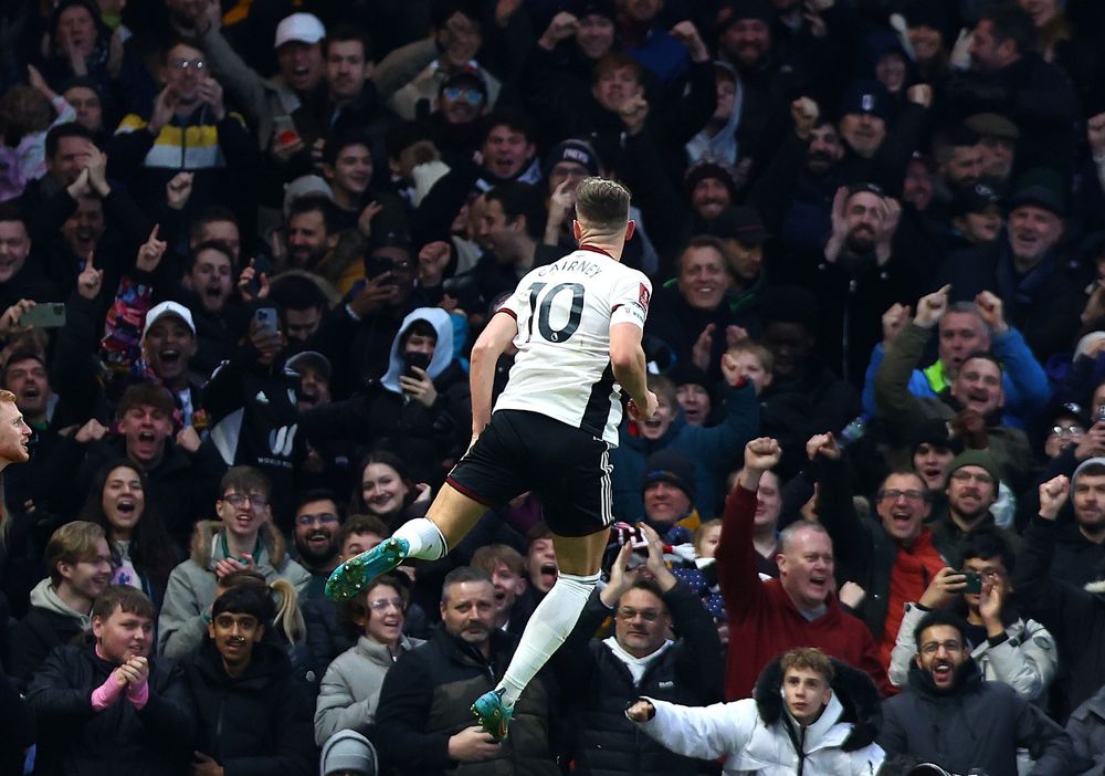 Tom Cairney celebrates his goal in front of the Hammy End