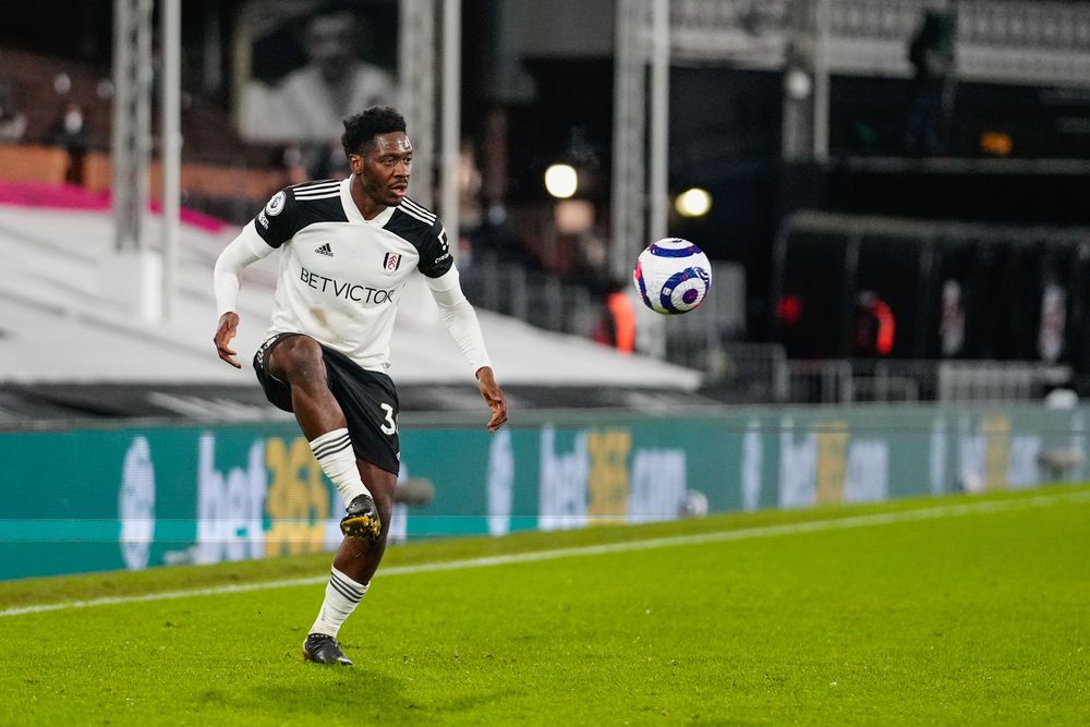 Ola Aina controls the ball