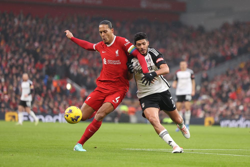 Virgil van Dijk battles with Raul Jimenez