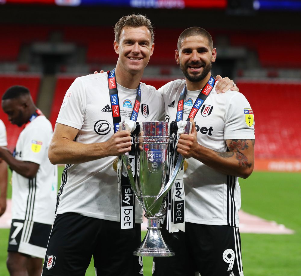 Kevin McDonald and Aleksandar Mitrović celebrate with the Championship Play-Off trophy in 2020