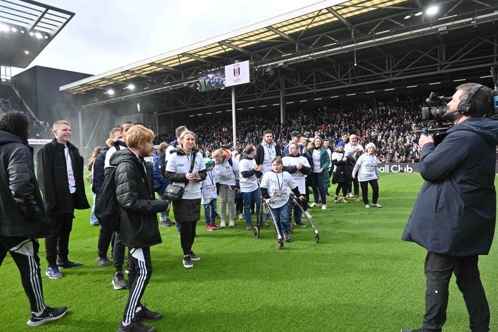 Matchday March participants on the pitch at half-time Matchday March participants on the pitch at half-time