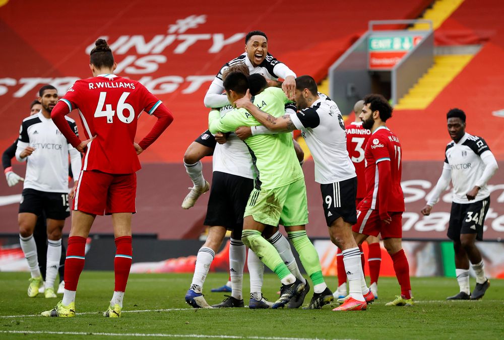 The Fulham players celebrate at full-time after defeating Liverpool