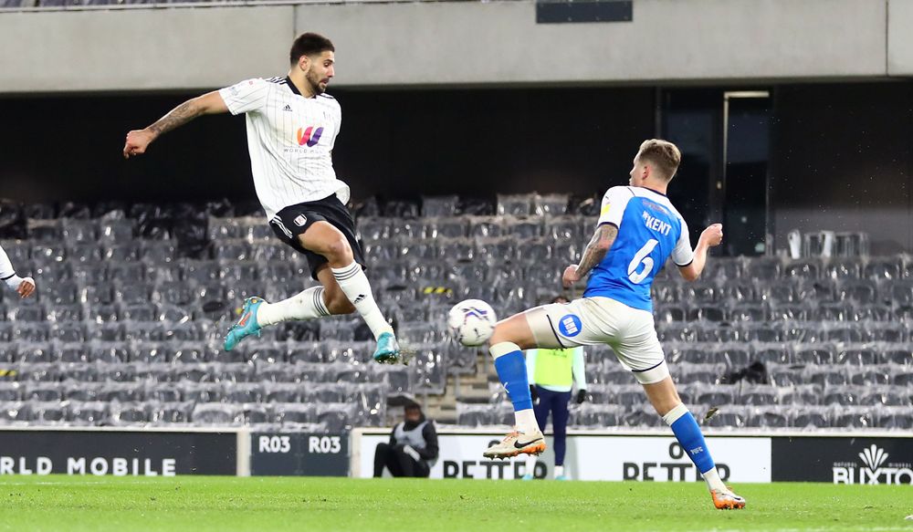Aleksandar Mitrović volleys in his second of the evening against Peterborough