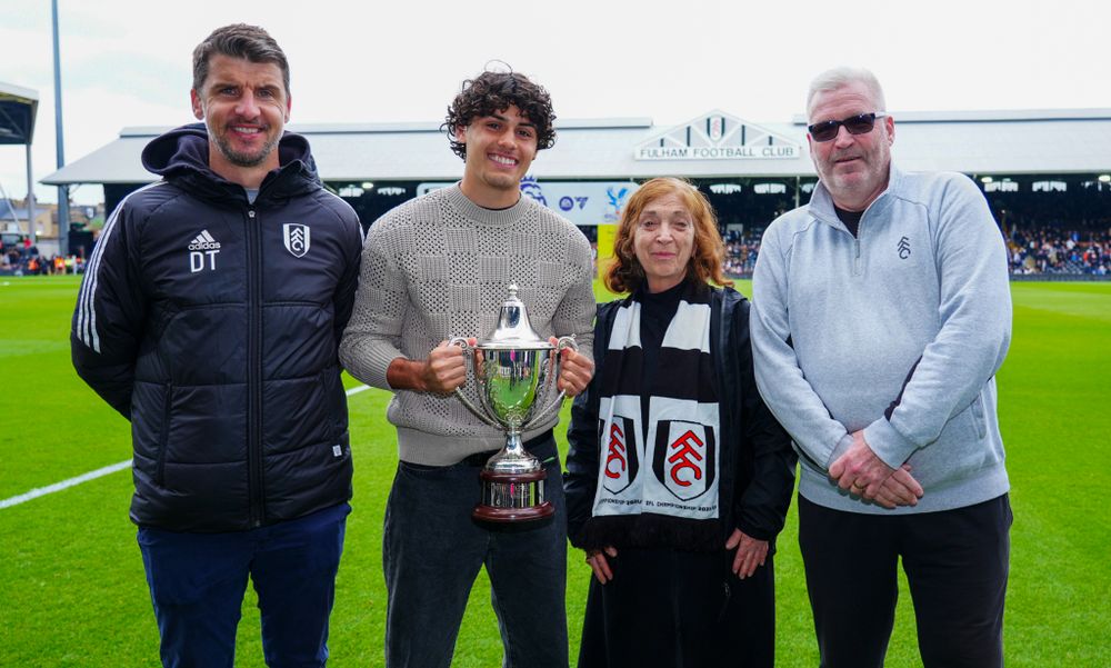 Devan Tanton is presented with the Johnny Haynes Trophy