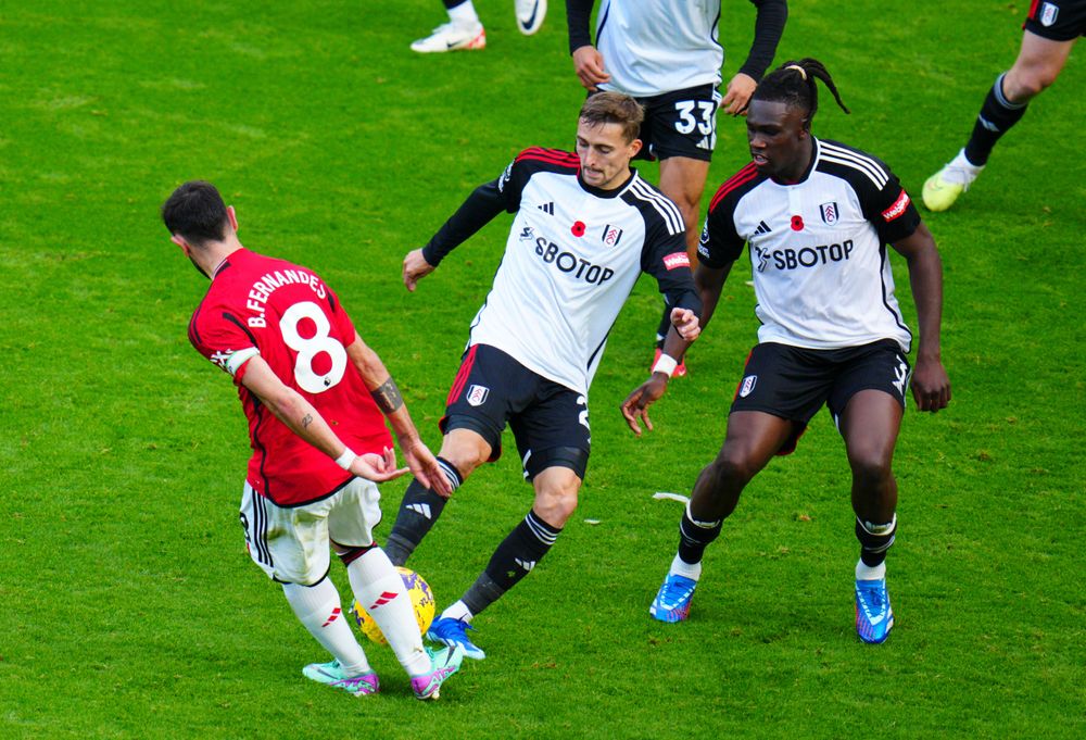 Timothy Castagne tackles Bruno Fernandes
