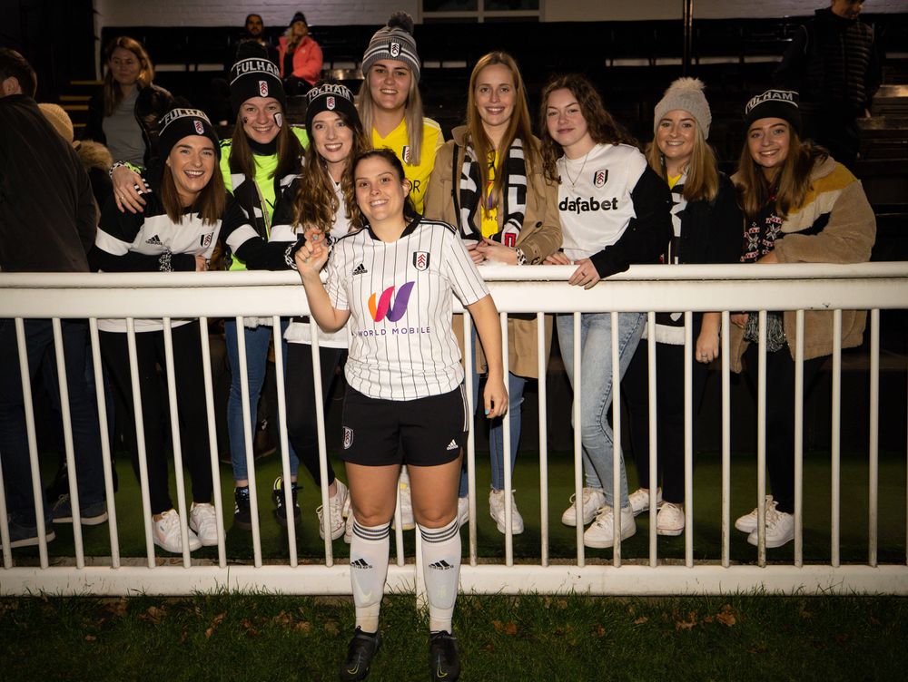 Fulham Women's Gemma Taylor poses with some fans after a game Fulham Women's Gemma Taylor poses with some fans after a game