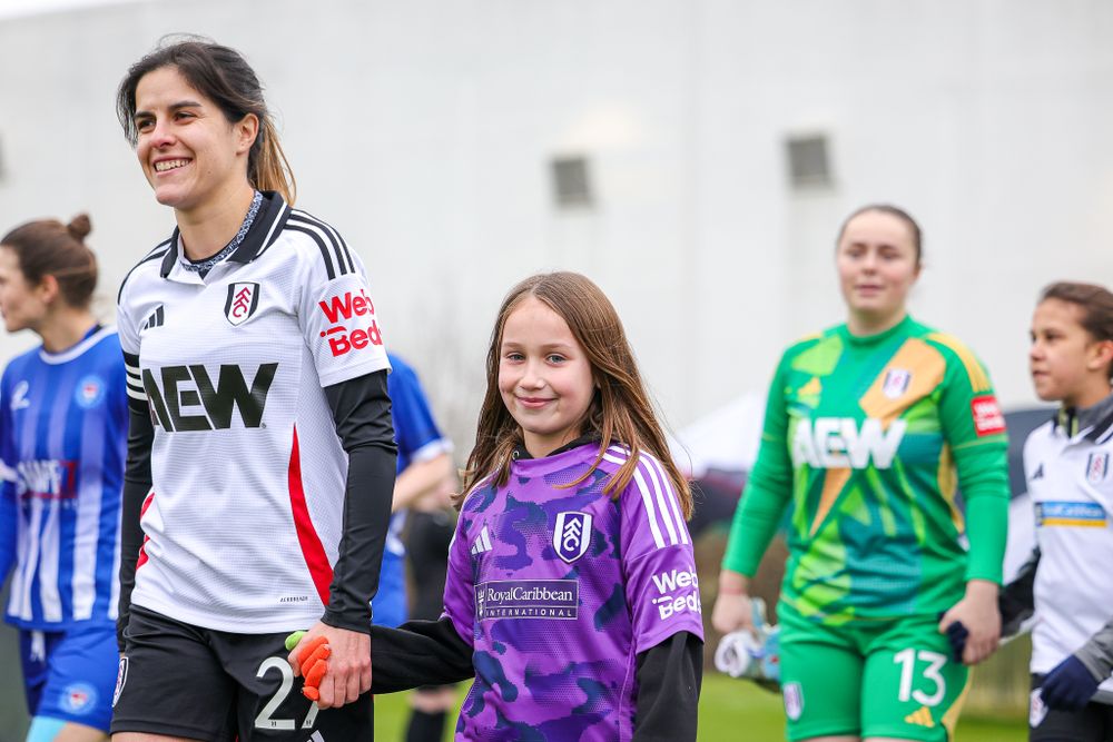 Megalie Mendes leads Fulham FC Women out onto the pitch Megalie Mendes leads Fulham FC Women out onto the pitch