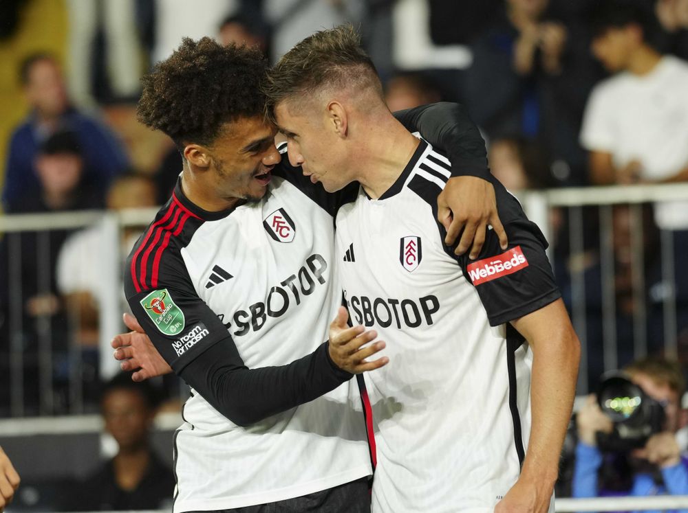 Antonee Robinson congratulates Tom Cairney on setting up the opening goal against Spurs Antonee Robinson congratulates Tom Cairney on setting up the opening goal against Spurs