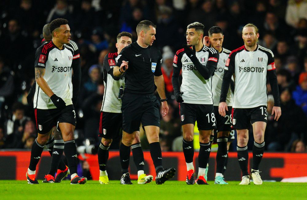 The Fulham players protest after the ball hits a hand in the lead up to Newcastle's goal. The Fulham players protest after the ball hits a hand in the lead up to Newcastle's goal.