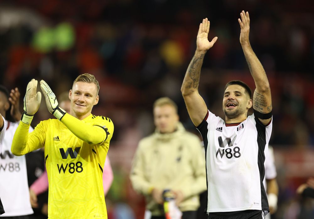 Bernd Leno and Aleksandar Mitrović celebrate with the Fulham fans following the win over Nottingham Forest