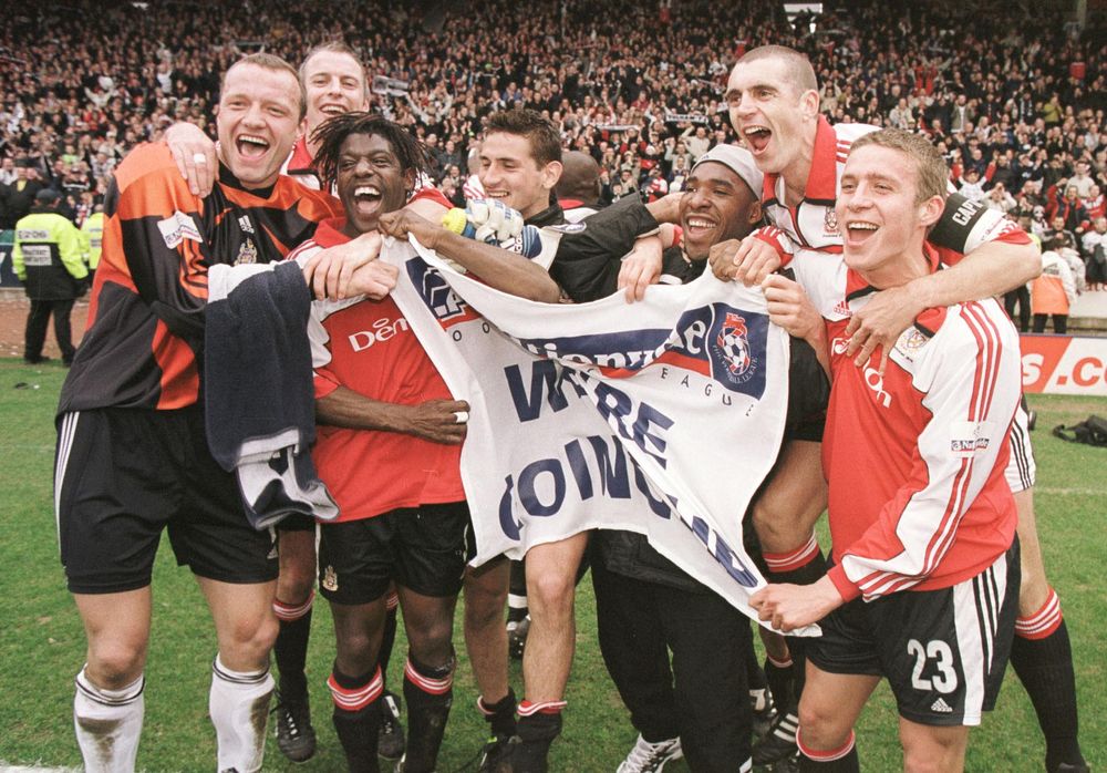 The Fulham players celebrate securing promotion at Huddersfield The Fulham players celebrate securing promotion at Huddersfield