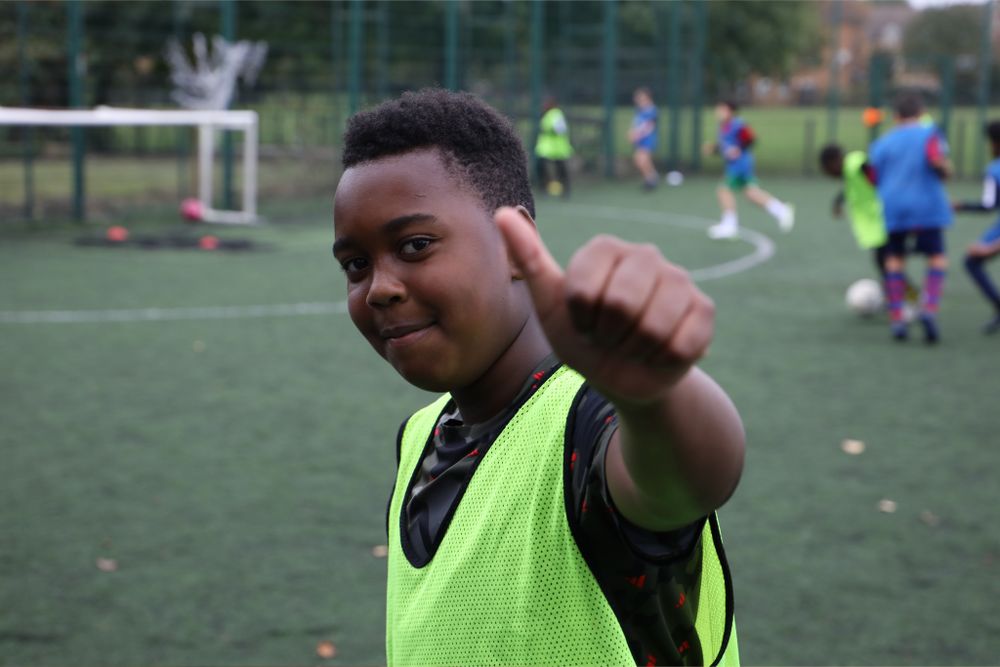 A Holiday Kicks participant puts his thumbs up to the camera during a session A Holiday Kicks participant puts his thumbs up to the camera during a session