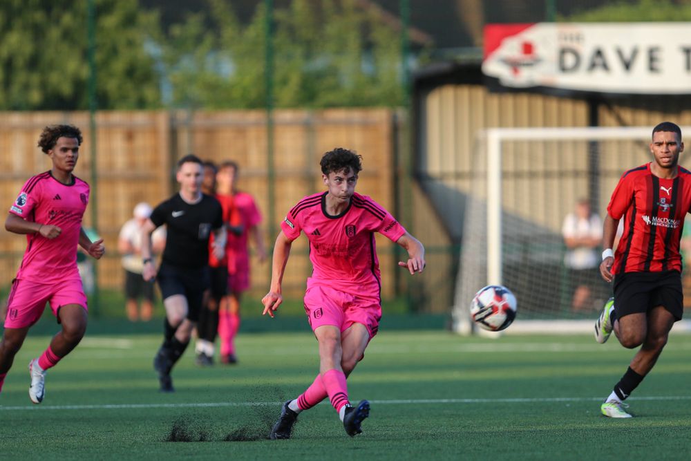 Fulham U18s striker Tom Wingate tries his luck from the halfway line against Cobham