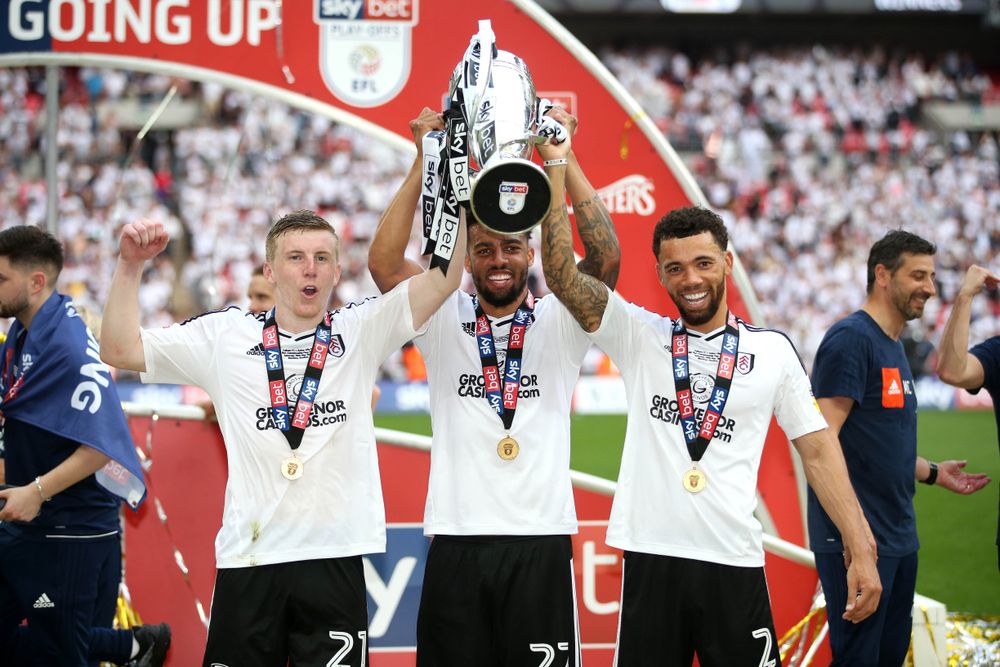 Fulham's full-backs - Matt Targett, Cyrus Christie and Ryan Fredericks - celebrate with the Play-Off trophy Fulham's full-backs - Matt Targett, Cyrus Christie and Ryan Fredericks - celebrate with the Play-Off trophy