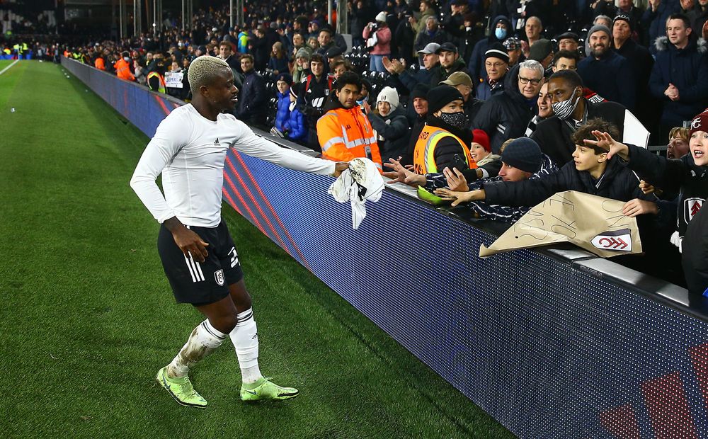 Jean Michaël Seri gives his shirt to a fan at full-time