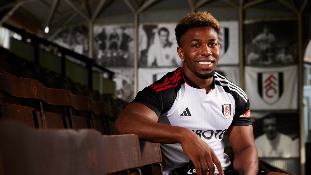 Adama Traoré sits in the Johnny Haynes Stand at Craven Cottage