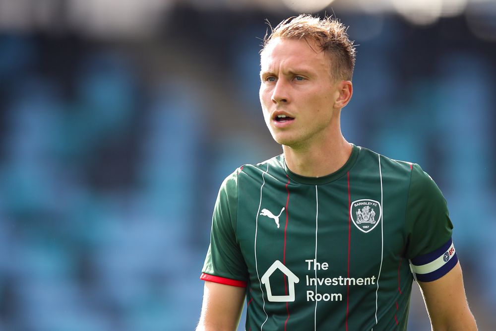 Cauley Woodrow captaining Barnsley in a pre-season friendly against Manchester City Cauley Woodrow captaining Barnsley in a pre-season friendly against Manchester City