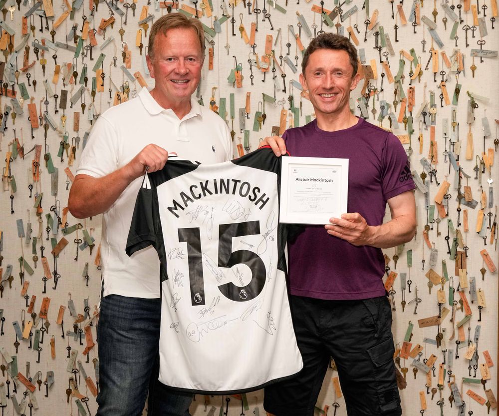 Dave Daly presents Alistair Mackintosh with a shirt to celebrate 15 years at Fulham