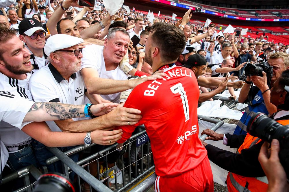 Vic and Marcus Bettinelli embrace at full-time at Wembley. Vic and Marcus Bettinelli embrace at full-time at Wembley.