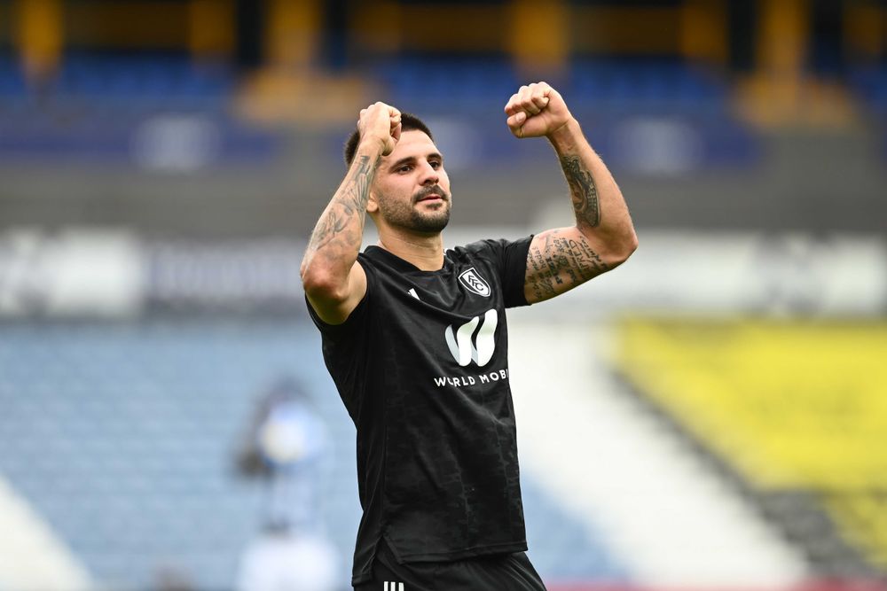 Aleksandar Mitrovic celebrates with the Fulham fans at full-time Aleksandar Mitrovic celebrates with the Fulham fans at full-time