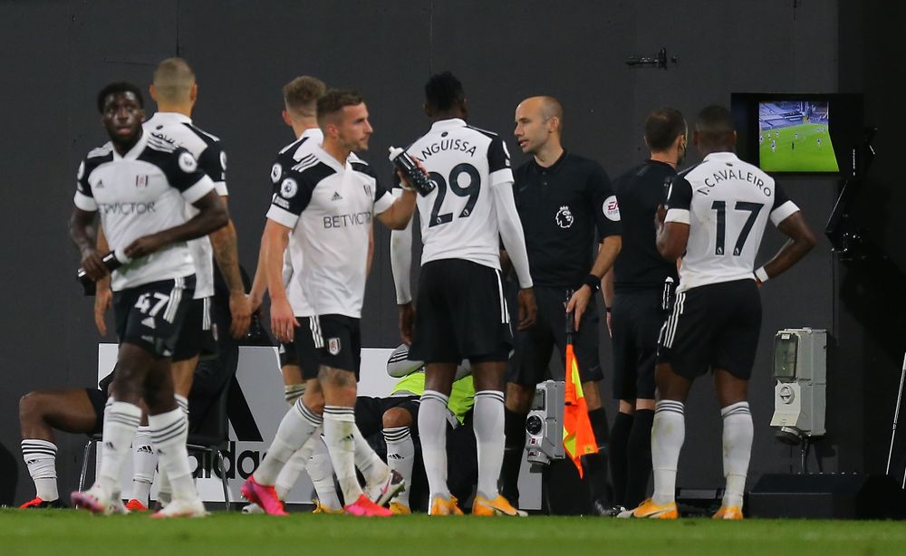 Referee Stuart Attwell investigates with VAR Bobby Reid of Fulham goal - which is not given. Referee Stuart Attwell investigates with VAR Bobby Reid of Fulham goal - which is not given.