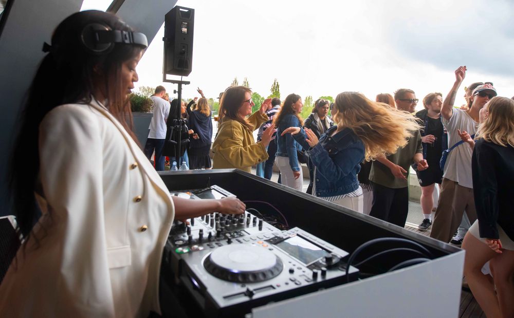 A DJ on the decks on Fulham Pier