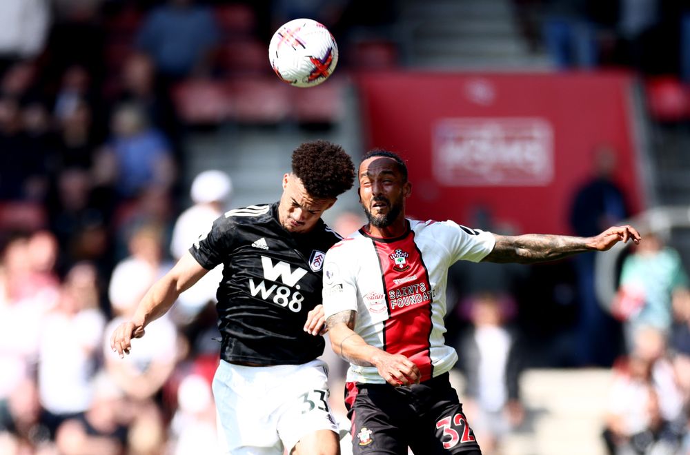 Antonee Robinson challenges with Theo Walcott in the air