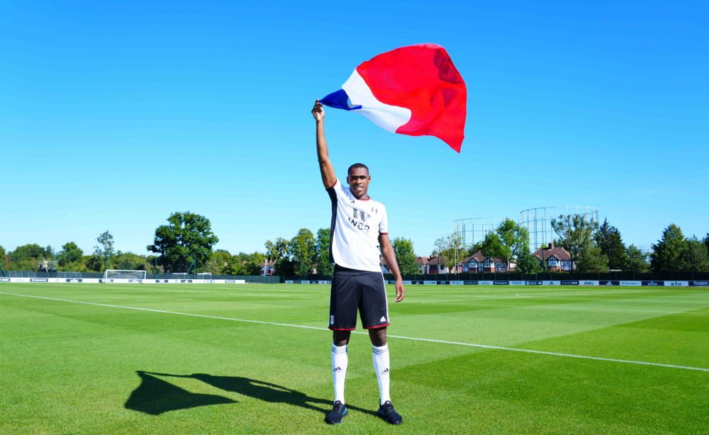 Issa Diop poses with a France flag at his signing