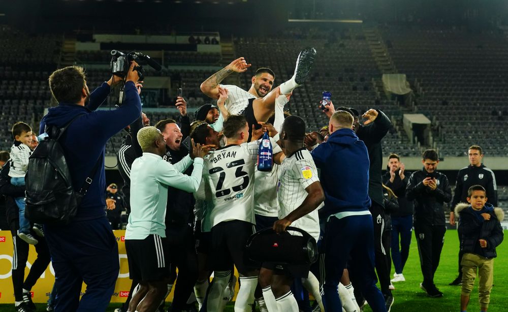 Joe Bryan celebrates with his teammates after Fulham's promotion is confirmed