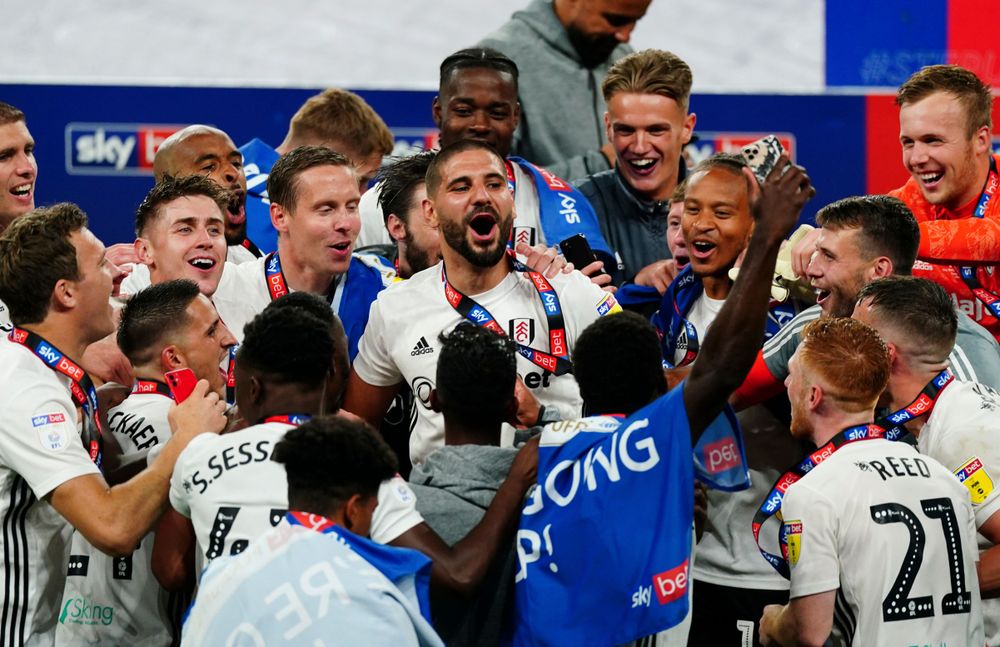 The Fulham players celebrate winning promotion