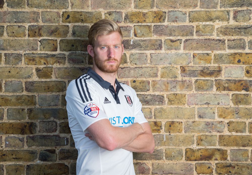 Tim Ream poses after signing for Fulham