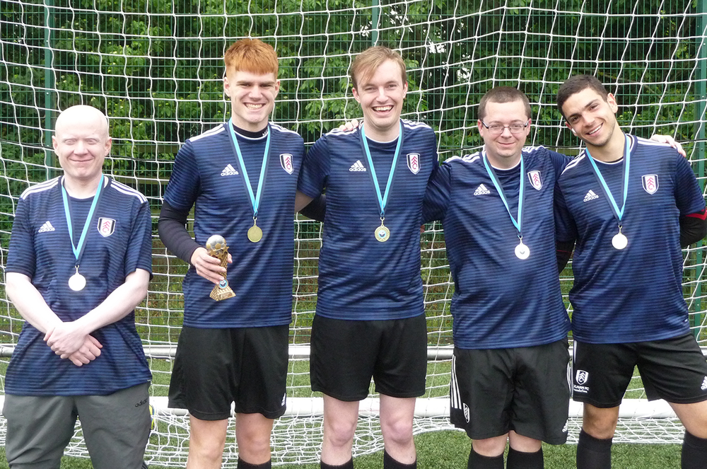 Adult players with their medals Adult players with their medals