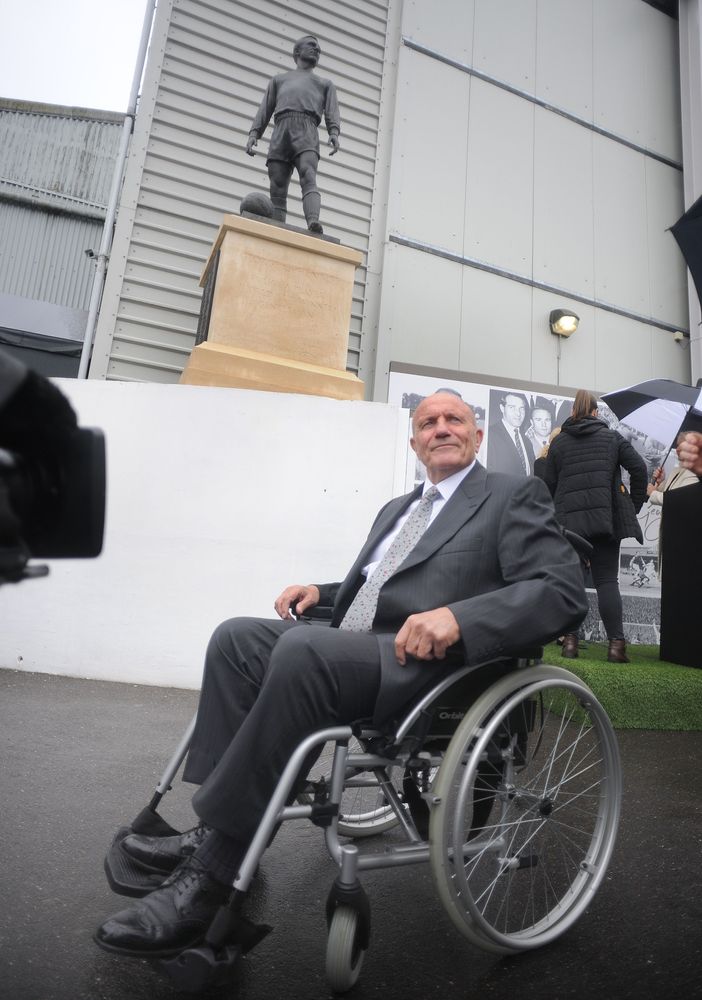 George poses with his statue