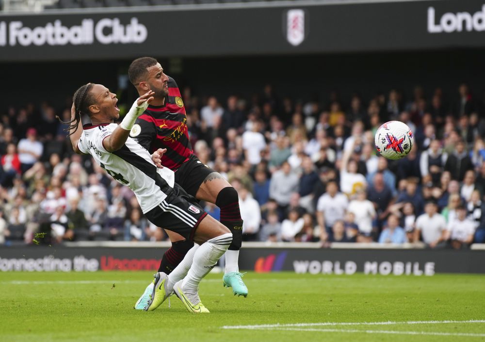 Kyle Walker drags Bobby De Cordova-Reid to the floor in the penalty area.