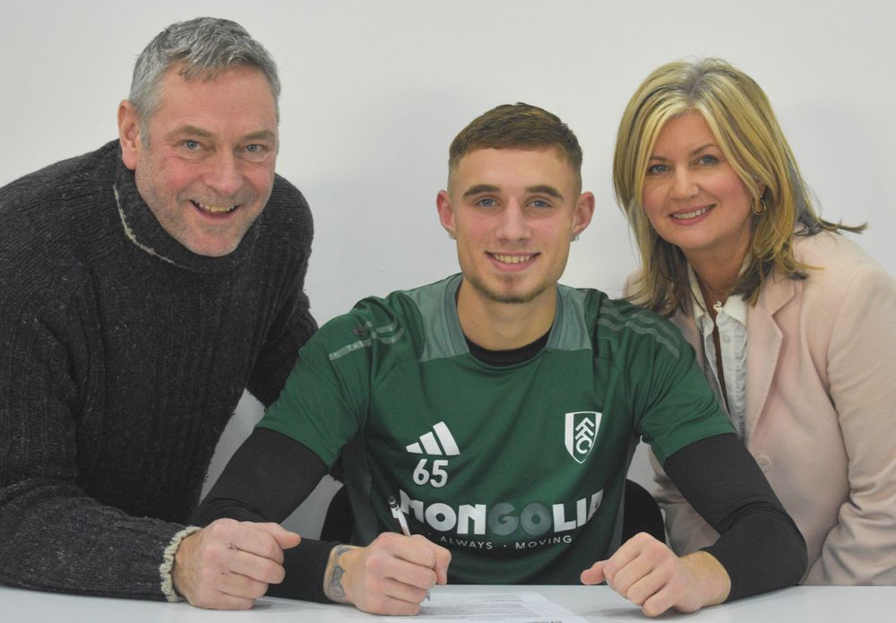 Marco Underwood poses with his parents after signing his first professional contract