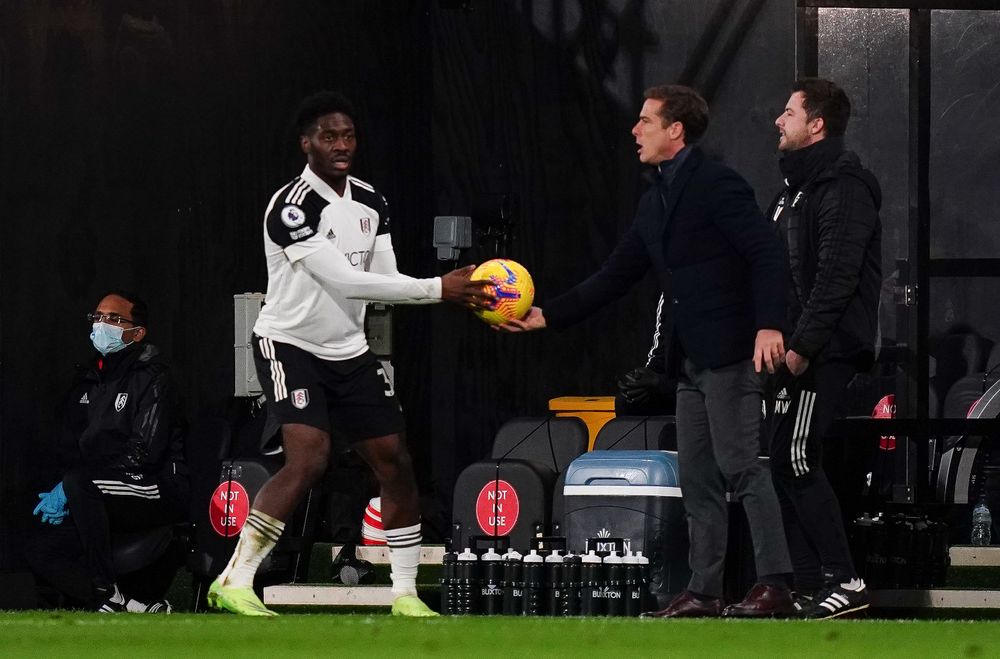Scott Parker hands the ball to Ola Aina. Scott Parker hands the ball to Ola Aina.