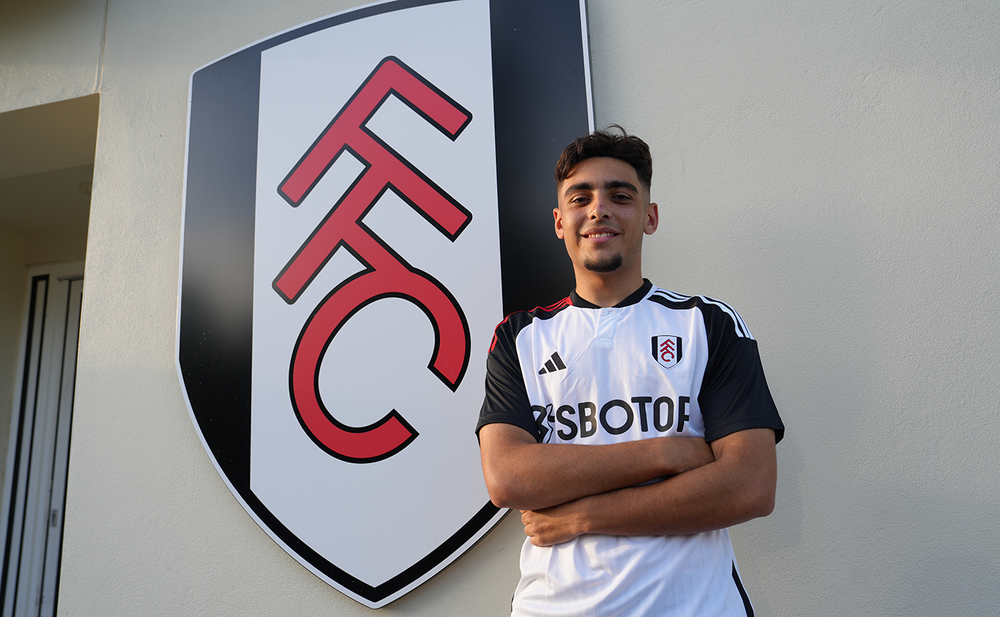 Matt poses in front of Fulham crest Matt poses in front of Fulham crest