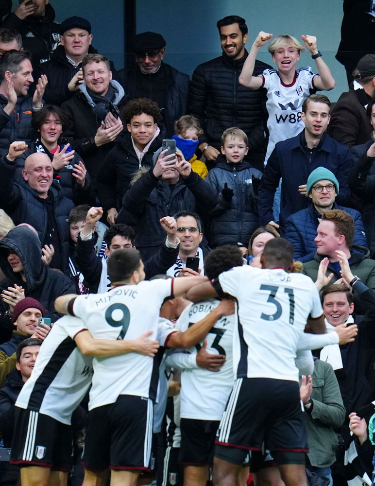 Fulham fans celebrate alongside the players