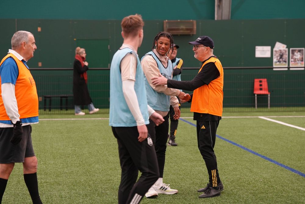 Walking football participants with Academy players Walking football participants with Academy players